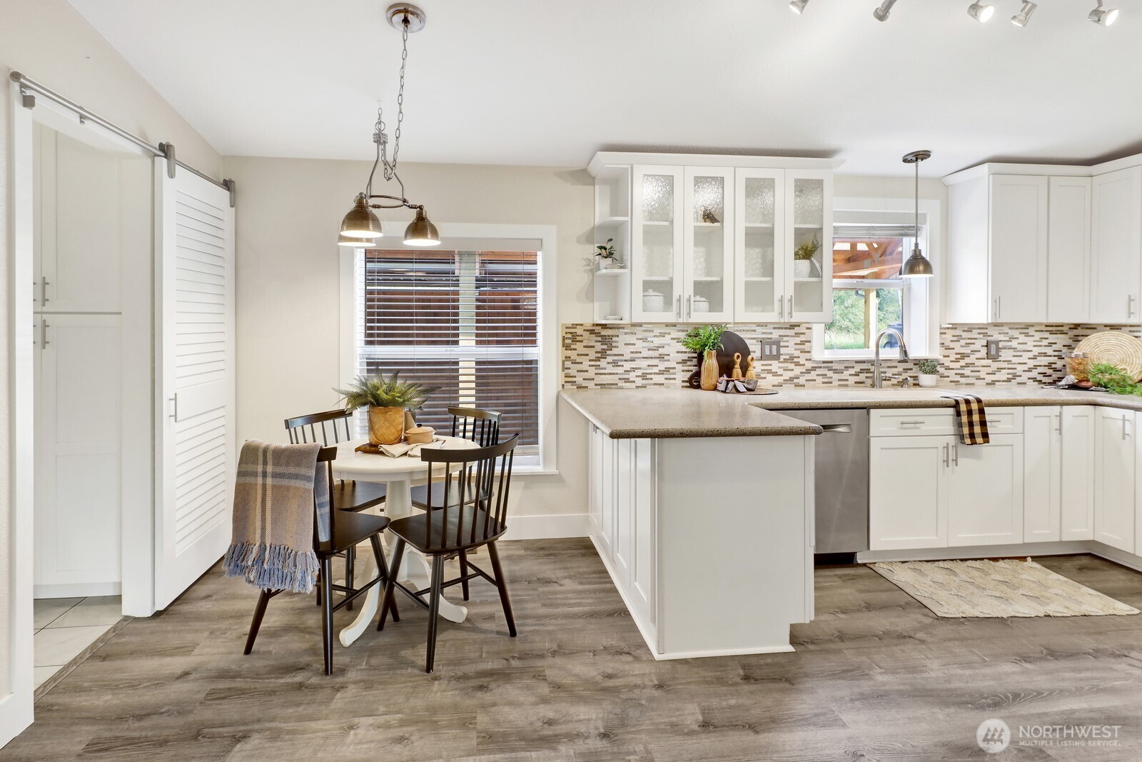 3240 Douglas Road Ferndale, WA 98248 - Photo 20 of 40 a kitchen with a table chairs refrigerator and cabinets