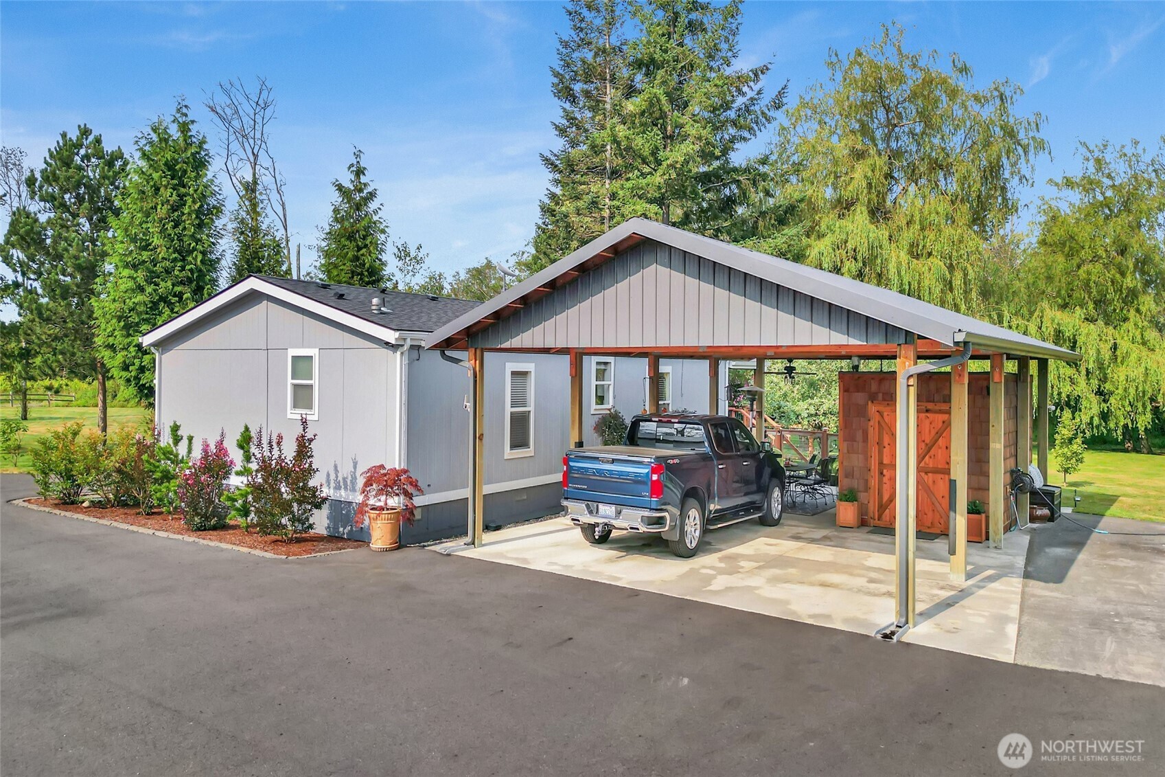 3240 Douglas Road Ferndale, WA 98248 - Photo 3 of 40 a car parked in front of house with wooden fence