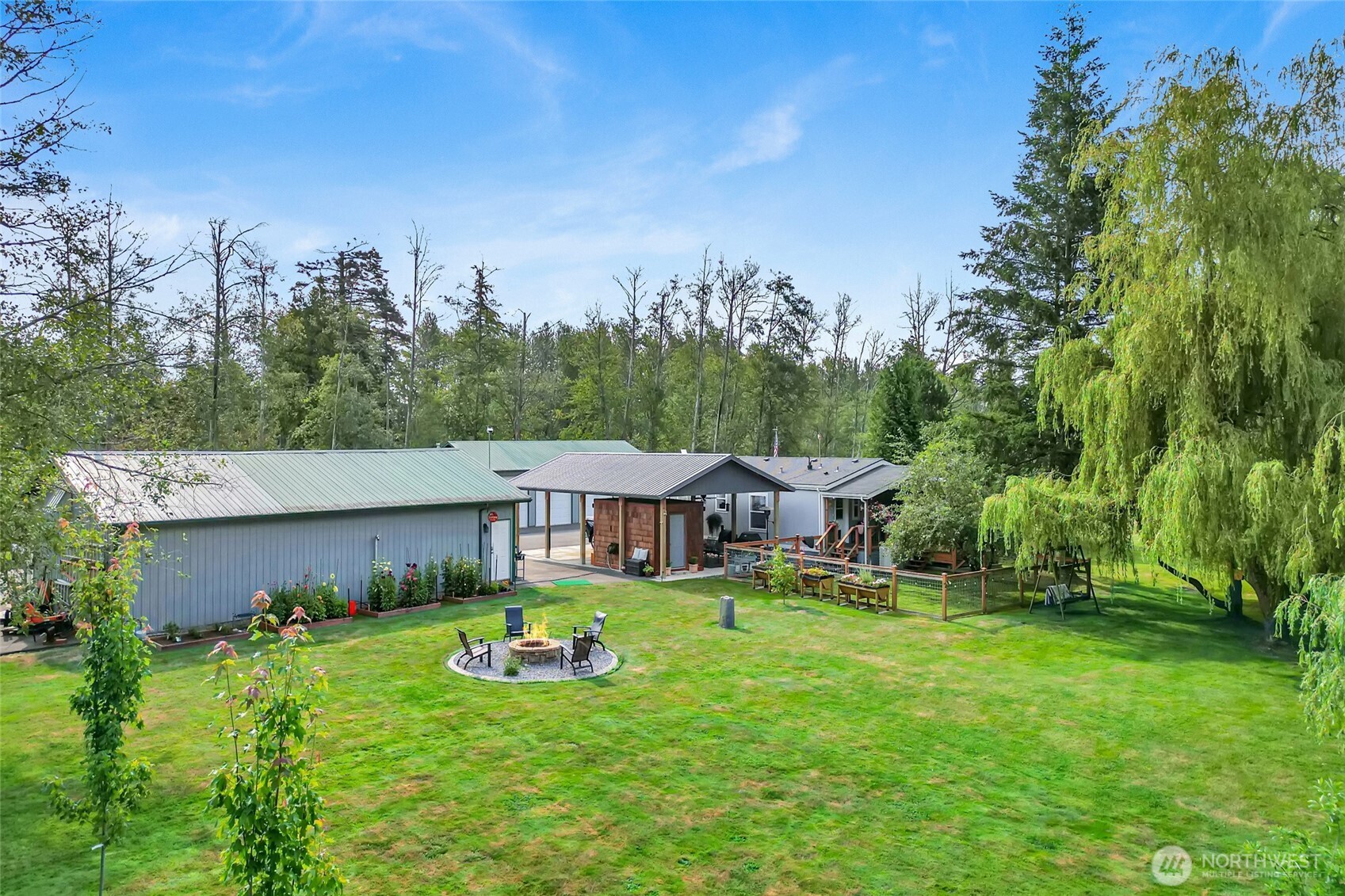 3240 Douglas Road Ferndale, WA 98248 - Photo 31 of 40 a view of a house with a big yard and sitting area
