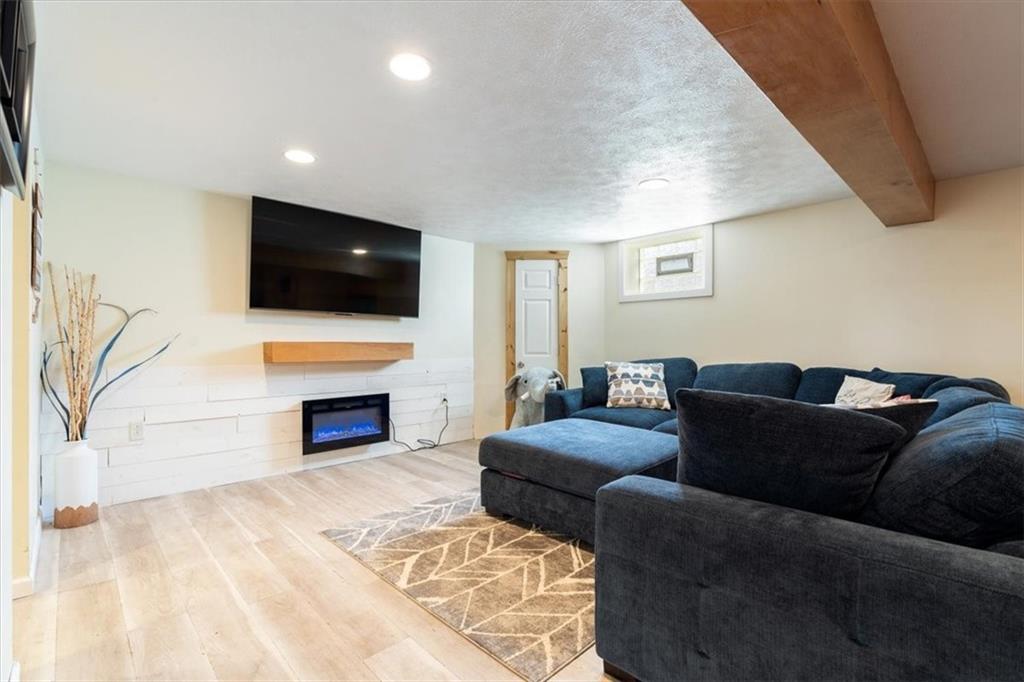 12490 Adams Drive Irwin, PA 15642 - Photo 15 of 33 a living room with furniture a fireplace and a flat screen tv