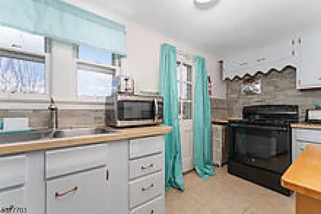 a kitchen with a sink and stainless steel appliances