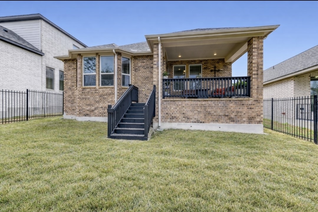 154 Kimble Creek Loop Kyle, TX 78640 - Photo 18 of 20 Rear view of property with a fenced backyard, brick siding, and a patio area