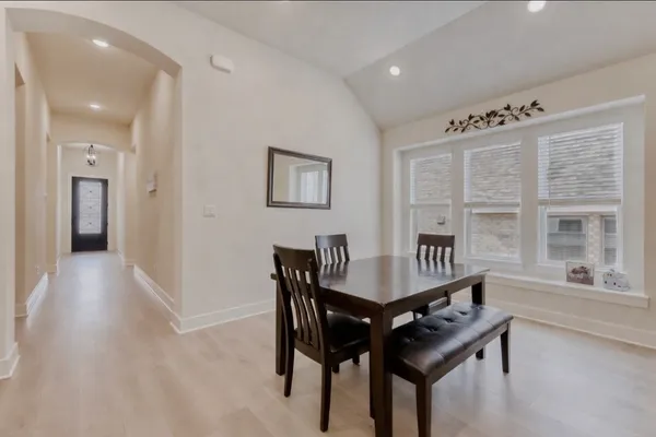 a view of a dining room with furniture and window