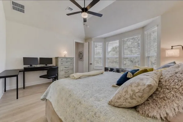 a bedroom with a bed and a chandelier