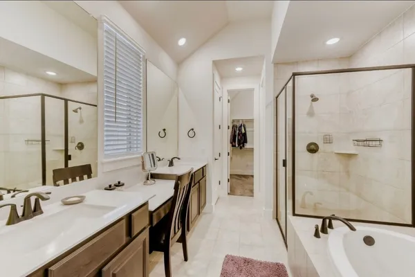 a bathroom with a double vanity sink mirror double and shower