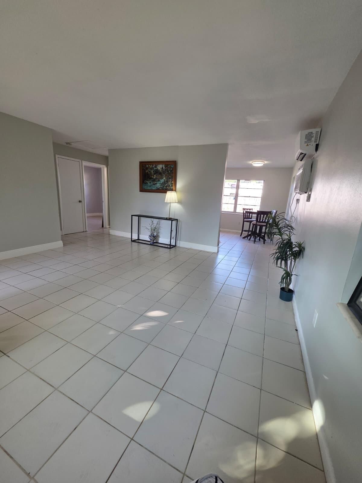 3386 Rudolph Road Lake Worth Beach, FL 33461 - Photo 8 of 25 a living room with furniture and a chandelier