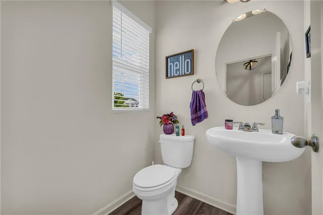 a kitchen with stainless steel appliances granite countertop a dining table chairs refrigerator and microwave