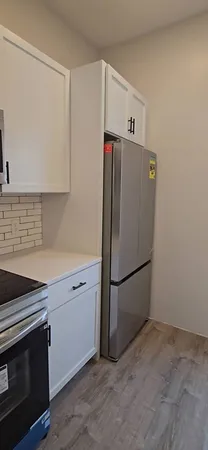 a white refrigerator freezer sitting in a kitchen