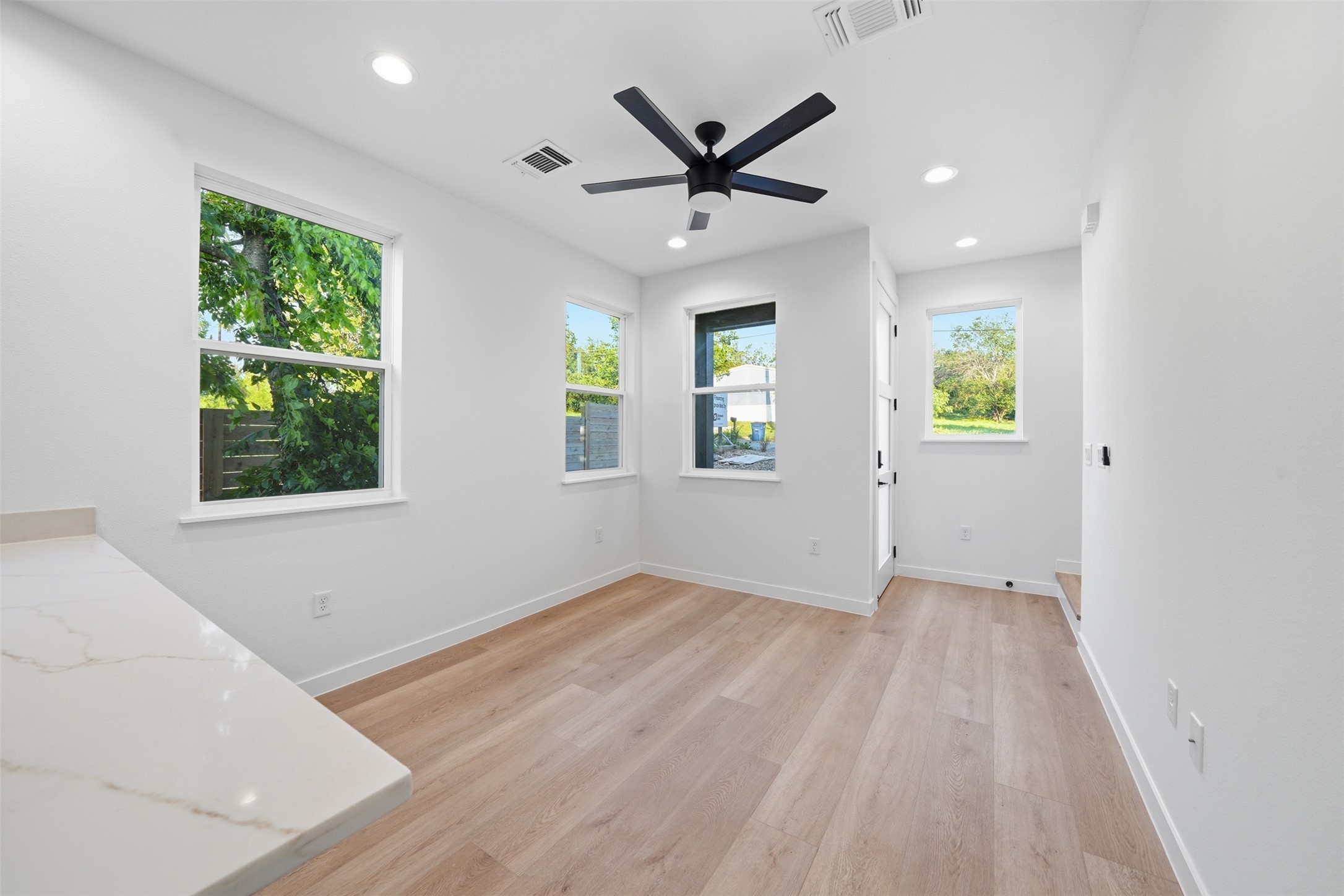 2212 Yellow Jacket Lane, Unit 2 Austin, TX 78741 - Photo 6 of 25 Bright living space featuring light wood-finish flooring, white walls, and recessed lighting