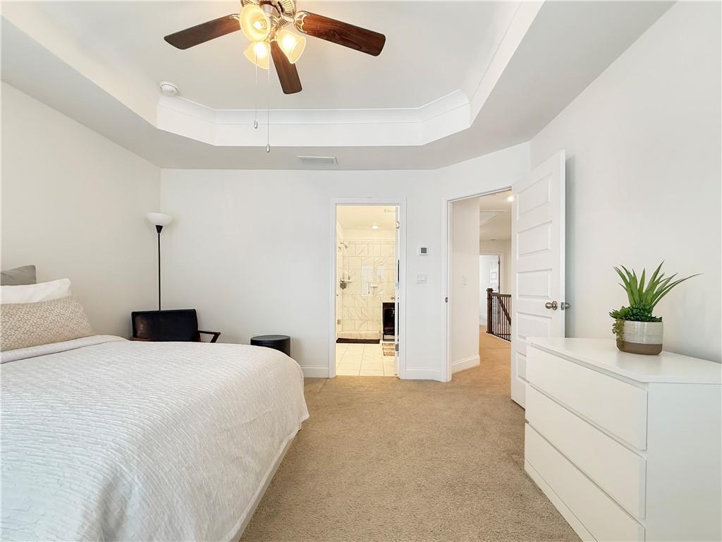1160 Kendron Lane, Unit 16 Atlanta, GA 30329 - Photo 21 of 39 a bedroom with a large bed and ceiling fan