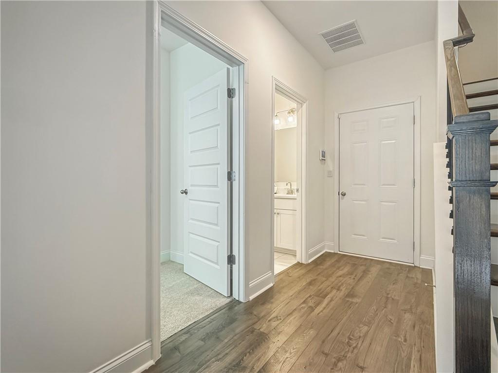 1160 Kendron Lane, Unit 16 Atlanta, GA 30329 - Photo 35 of 39 a view of a hallway with wooden floor