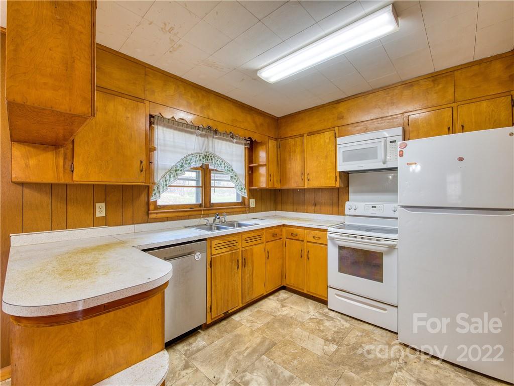 208 Balsam Ridge Road Waynesville, NC 28786 - Photo 11 of 25 a kitchen with stainless steel appliances granite countertop a sink stove and refrigerator