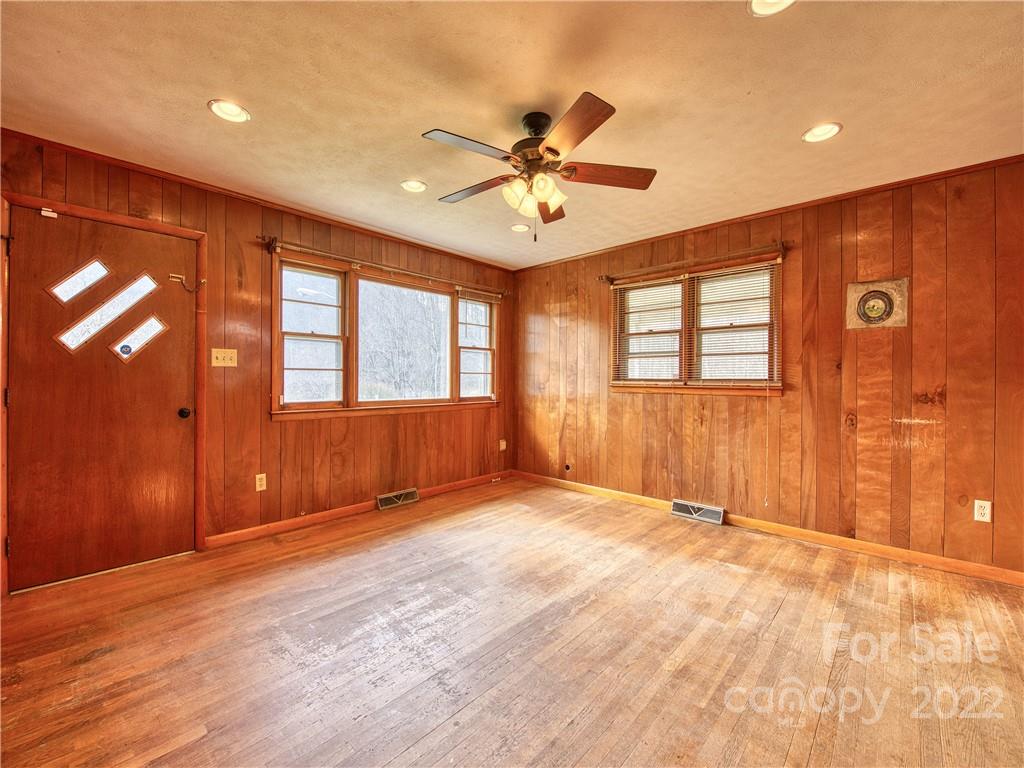 208 Balsam Ridge Road Waynesville, NC 28786 - Photo 14 of 25 a view of an empty room with window and wooden floor