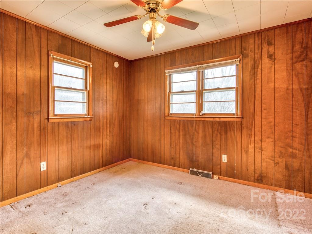 208 Balsam Ridge Road Waynesville, NC 28786 - Photo 20 of 25 an empty room with windows and fan