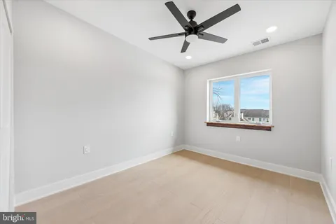 a bedroom with a large bed couch and a window