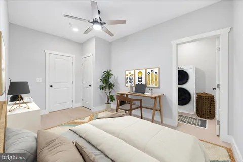 an empty room with a window and a ceiling fan