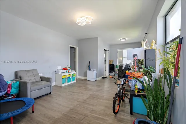 a bedroom with a bed and a wooden floor