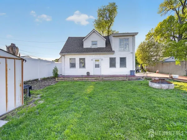 a view of a house with a backyard porch and sitting area