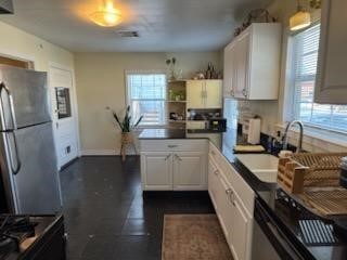 932 Walling Street Houston, TX 77009 - Photo 9 of 23 a kitchen with a sink stove and refrigerator