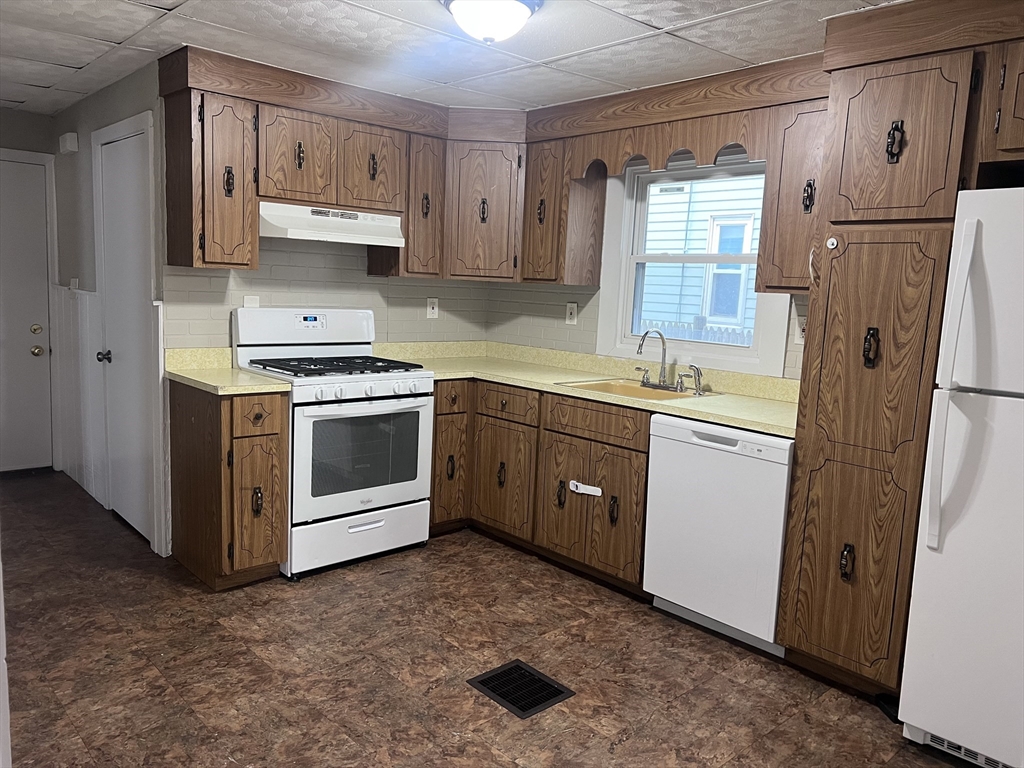 234 Clark Avenue, Unit 1 Chelsea, MA 02150 - Photo 1 of 6 a kitchen with stainless steel appliances granite countertop a sink stove and refrigerator