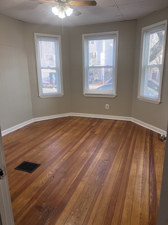 234 Clark Avenue, Unit 1 Chelsea, MA 02150 - Photo 2 of 6 a view of an empty room with wooden floor and a window