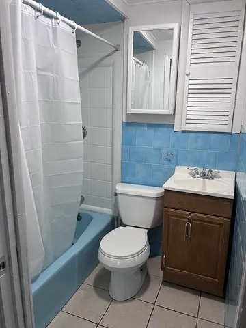 a bathroom with a toilet a sink and a shower