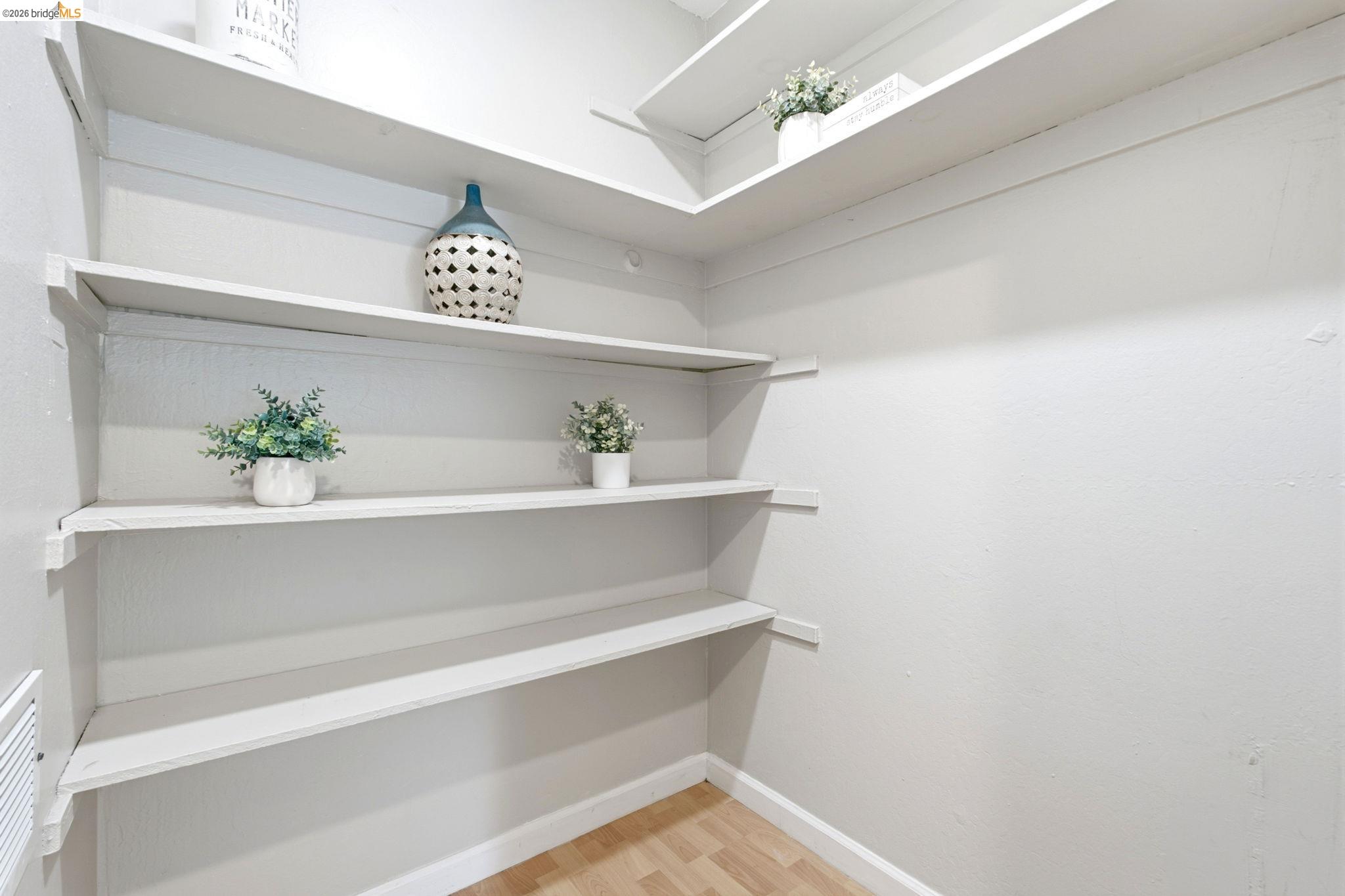 4081 Clayton Road, Unit 209 Concord, CA 94521 - Photo 20 of 47 Built-in shelving providing ample storage, light-colored walls, and wood-finish flooring