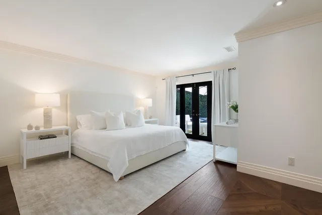 a room with double bed windows and a couch