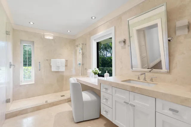 a bathroom with a granite countertop sink a toilet and a mirror