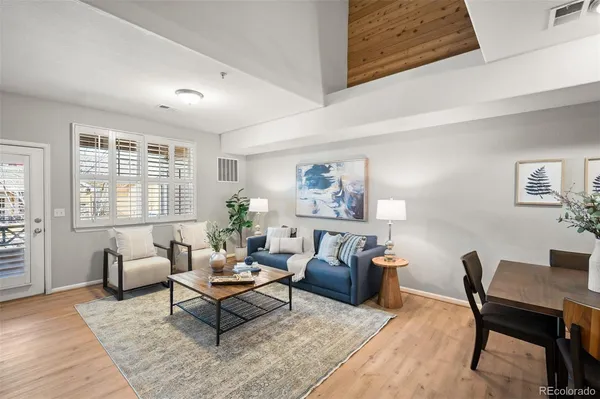 a living room with furniture rug and window