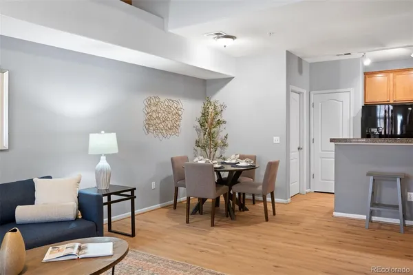 a kitchen with granite countertop stainless steel appliances a stove refrigerator and cabinets