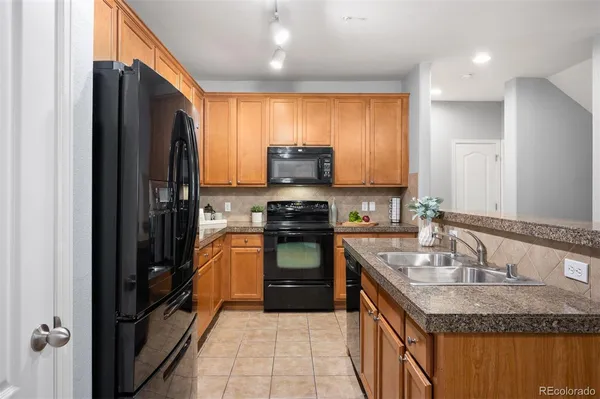a kitchen with a refrigerator stove and sink