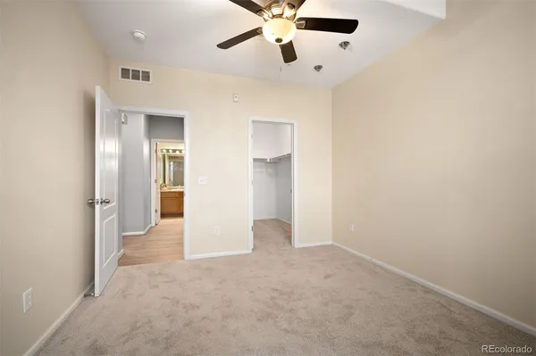 a bathroom with a granite countertop sink toilet a large mirror a shower and a bathtub