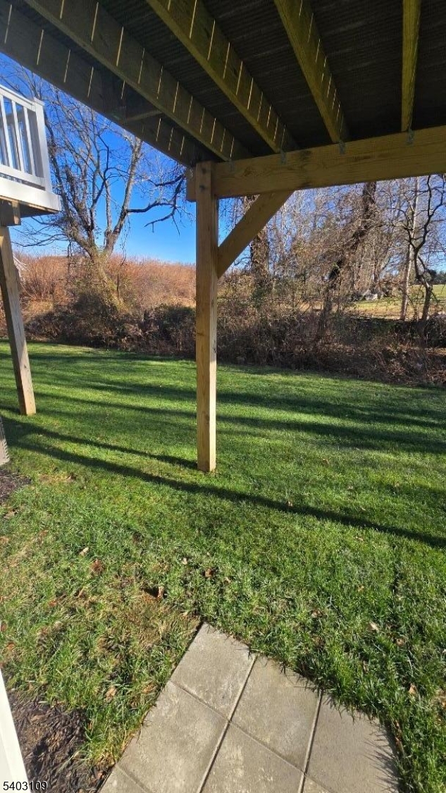 11 Limestone Boulevard Washington, NJ 07882 - Photo 16 of 18 a view of a backyard with table and chairs under an umbrella