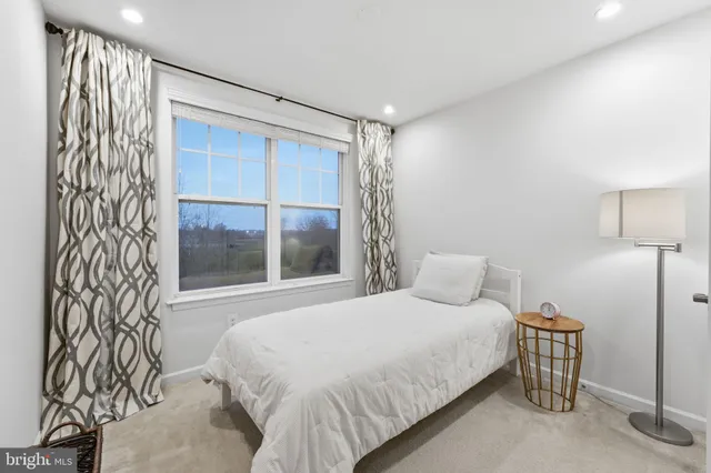 a bedroom with a large bed and wooden floor
