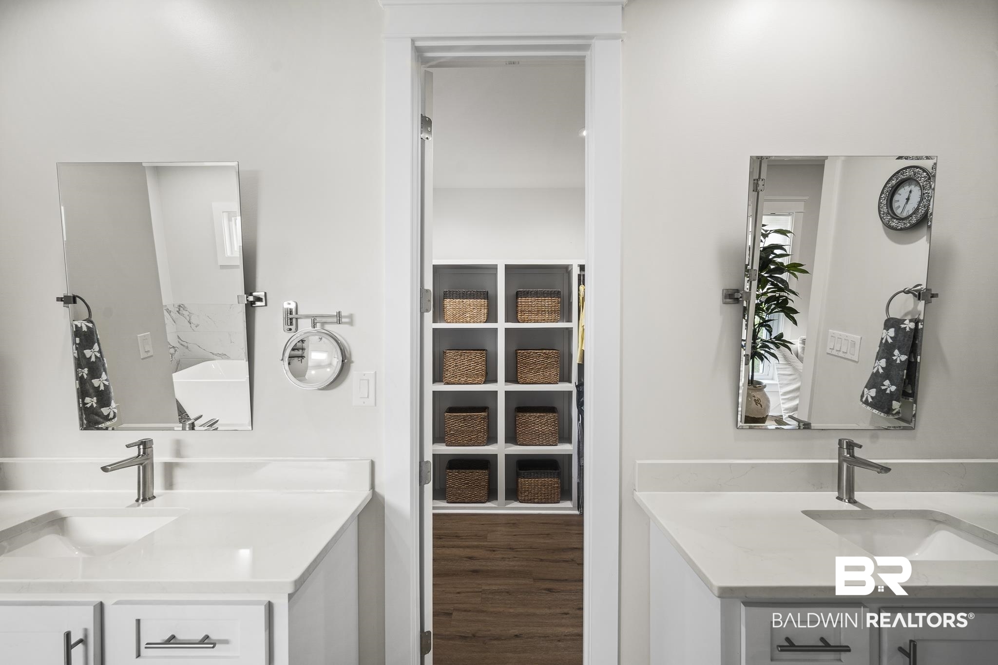 21702 Pillars Street Fairhope, AL 36532 - Photo 22 of 54 Dual vanity with undermount sinks and white countertops, featuring chrome fixtures and wall-mounted mirrors