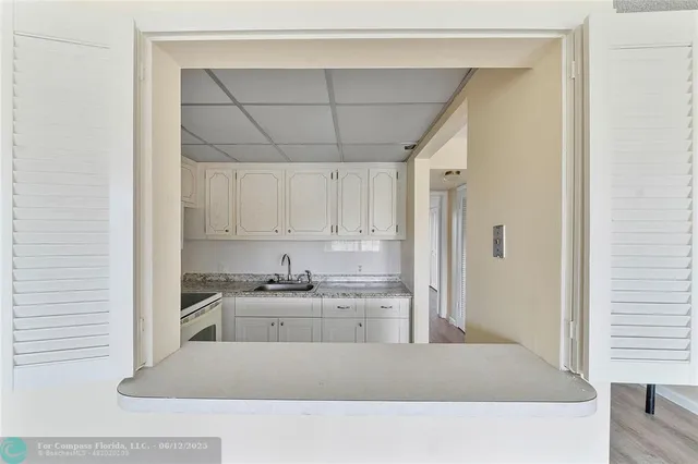a kitchen with a sink a stove and cabinets