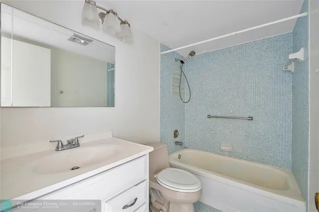 a bathroom with a sink toilet tub vanity and shower
