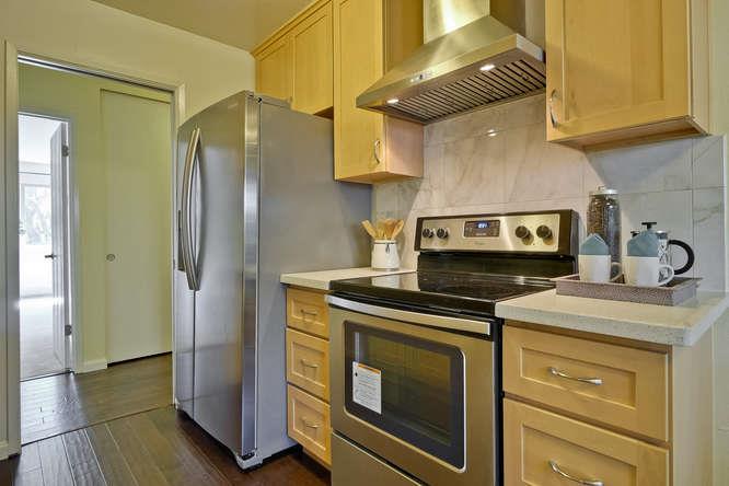 100 East Middlefield Road, Unit 2B Mountain View, CA 94043 - Photo 11 of 28 a kitchen with stainless steel appliances granite countertop a stove and a refrigerator