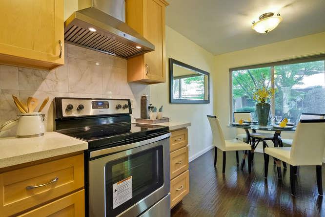 100 East Middlefield Road, Unit 2B Mountain View, CA 94043 - Photo 12 of 28 a kitchen with a stove and a table chair