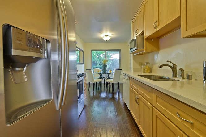 100 East Middlefield Road, Unit 2B Mountain View, CA 94043 - Photo 13 of 28 a kitchen with sink cabinets and wooden floor