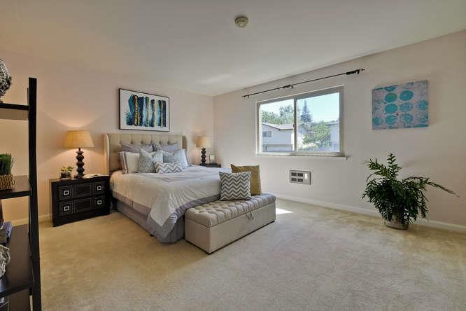 100 East Middlefield Road, Unit 2B Mountain View, CA 94043 - Photo 14 of 28 a bedroom with a bed and a potted plant