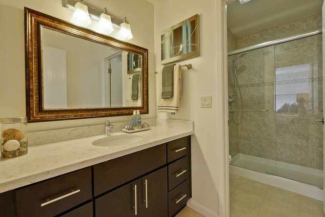 100 East Middlefield Road, Unit 2B Mountain View, CA 94043 - Photo 16 of 28 a bathroom with a granite countertop sink mirror and a bathtub