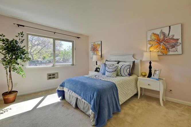 100 East Middlefield Road, Unit 2B Mountain View, CA 94043 - Photo 19 of 28 a bedroom with a bed and a potted plant