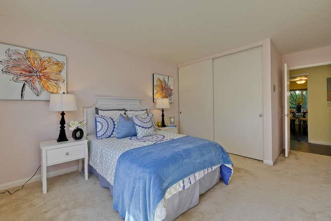 100 East Middlefield Road, Unit 2B Mountain View, CA 94043 - Photo 20 of 28 a bedroom with a bed and a lamp on the dresser