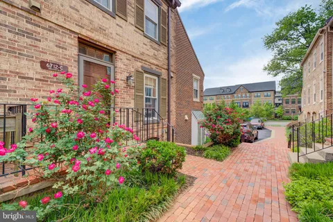 a view of a house with a lot of flower plants