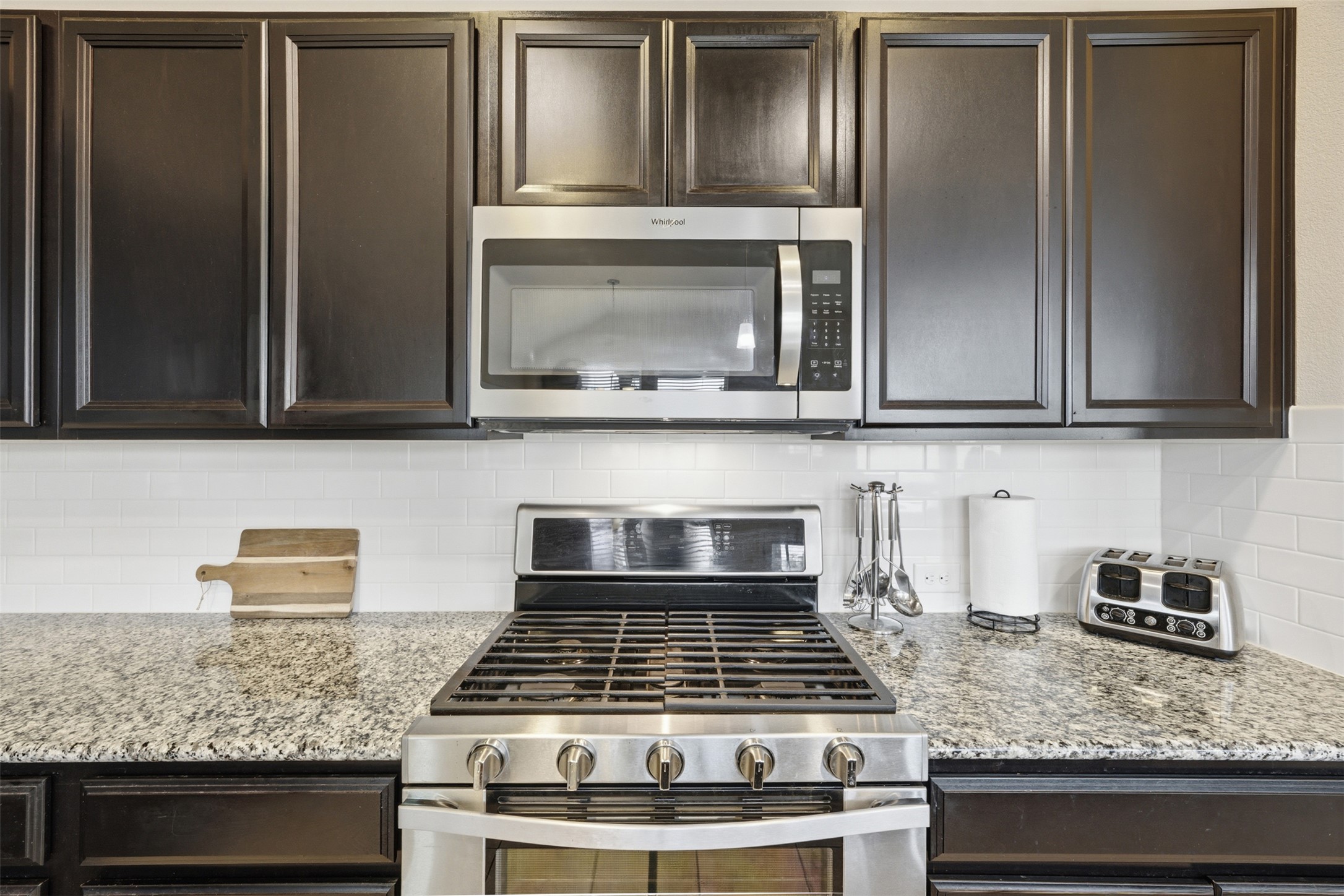 276 Gunnison Way Kyle, TX 78640 - Photo 9 of 28 a kitchen with granite countertop stainless steel appliances and cabinets