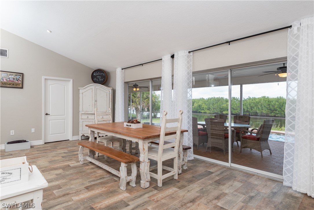 7600 Riverside Drive Punta Gorda, FL 33982 - Photo 8 of 35 a view of a dining room with furniture window and wooden floor