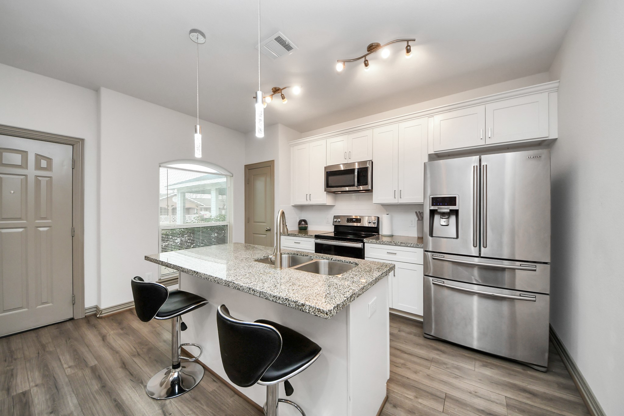 5334 Pershing Street Houston, TX 77033 - Photo 35 of 43 a kitchen with kitchen island white cabinets and stainless steel appliances