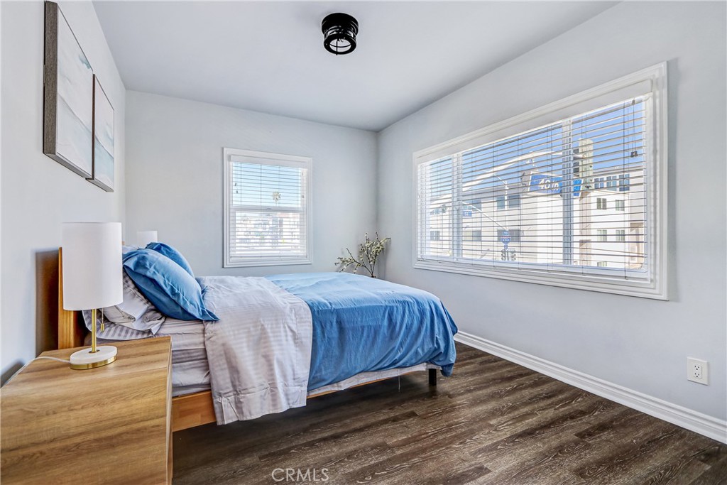230 40th Street, Unit 1 Manhattan Beach, CA 90266 - Photo 12 of 19 a bedroom with a bed and wooden floor